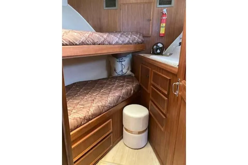 Slide: The Image of Cozy cabin interior of 1979 Hatteras 46 Convertible with bunk beds and wooden cabinetry. - 16