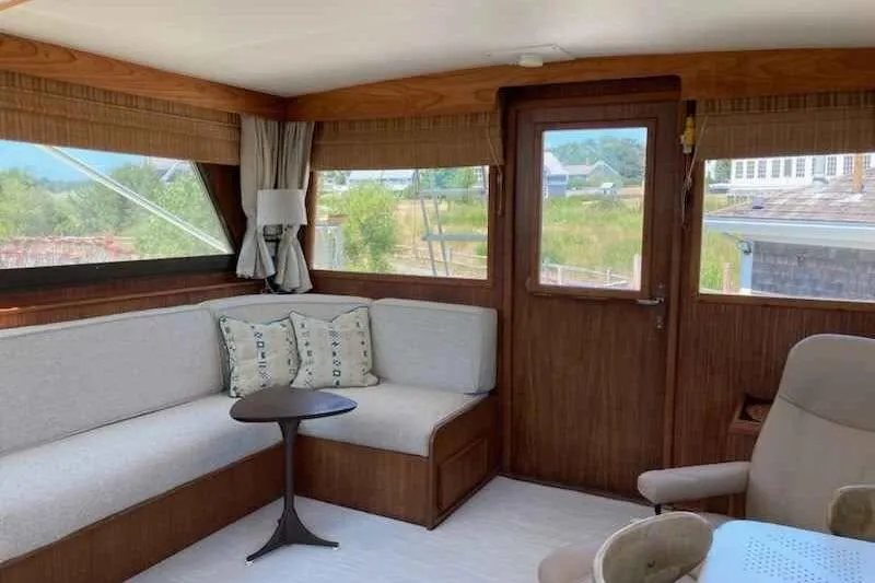 Slide: The Image of Interior of 1979 Hatteras 46 Convertible yacht with cozy seating and wooden accents. - 2