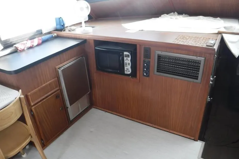 Slide: The Image of Interior of 1979 Hatteras 46 Convertible yacht with microwave and wooden cabinetry. - 3