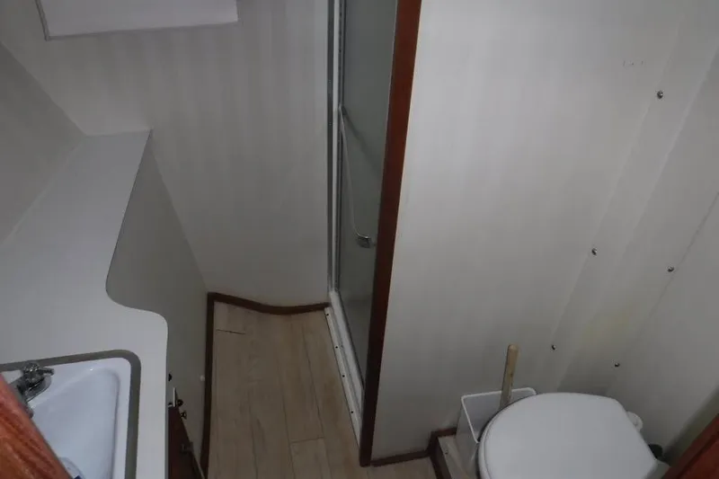 Slide: The Image of Bathroom interior of 1979 Hatteras 46 Convertible yacht, featuring sink, toilet, and shower. - 5