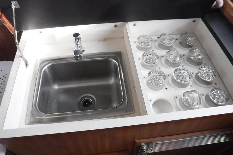 Slide: The Image of Stainless steel sink and glass storage on 1979 Hatteras 46 Convertible yacht. - 8