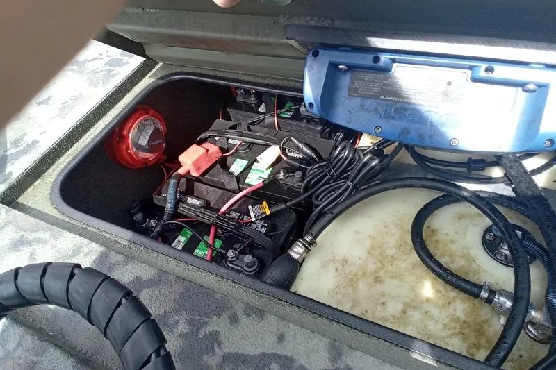 Slide: The Image of 2021 Excel 1860 Stalker SC boat battery compartment with wiring and components. - 11