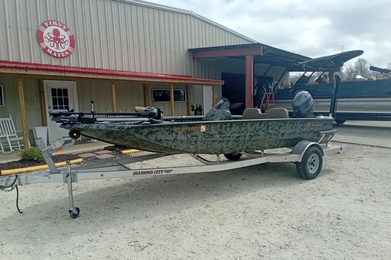 Slide: The Image of 2021 Excel 1860 Stalker SC boat on trailer outside a metal building. - 3