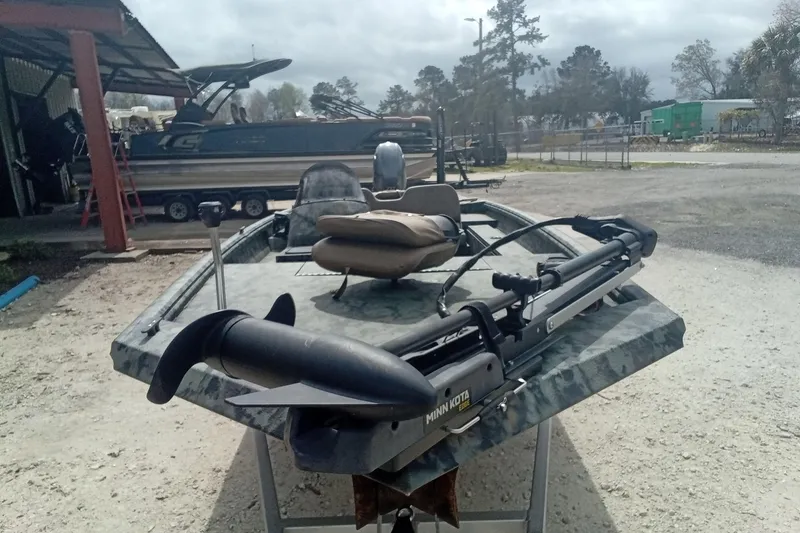 Slide: The Image of 2021 Excel 1860 Stalker SC boat with Minn Kota trolling motor in outdoor setting. - 5