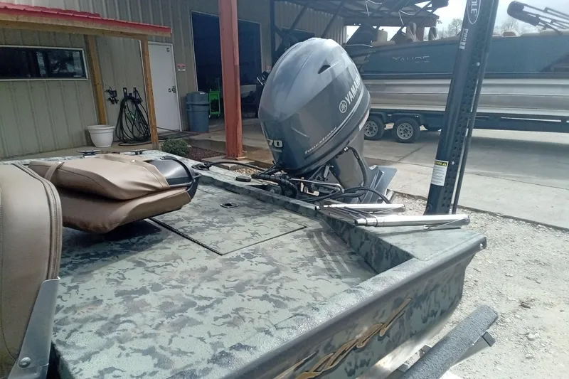 Slide: The Image of 2021 Excel 1860 Stalker SC boat with Yamaha outboard motor in a storage area. - 7