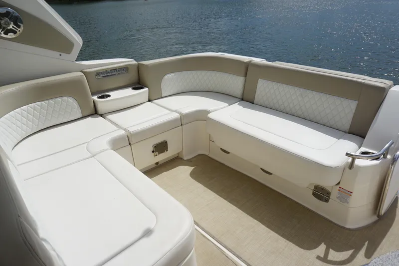 Slide: The Image of Luxurious seating area on 2014 Chaparral 330 Signature boat, overlooking serene water. - 14