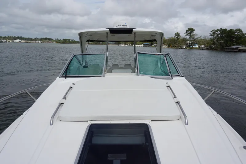 Slide: The Image of 2014 Chaparral 330 Signature boat on a calm lake with overcast sky. - 15