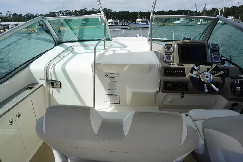 Slide: The Image of 2014 Chaparral 330 Signature boat cockpit with steering wheel and control panel. - 22