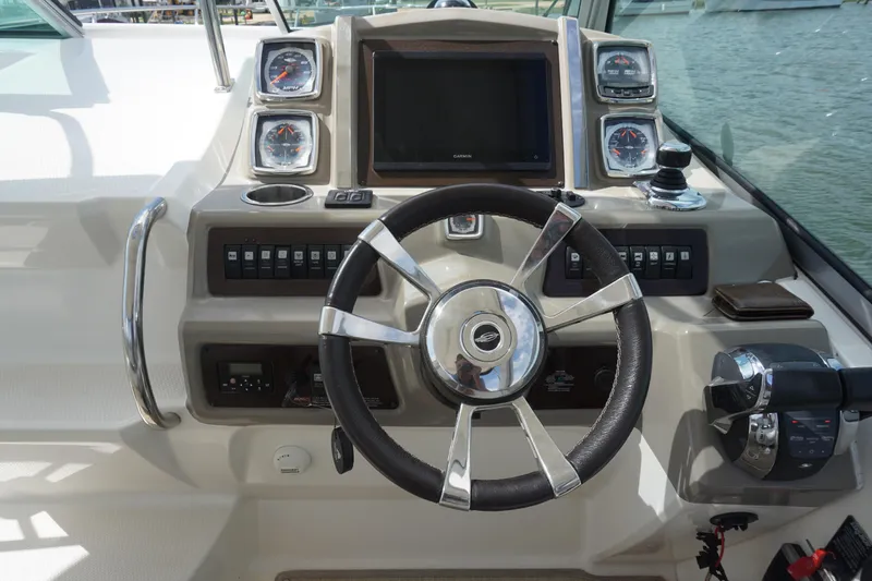 Slide: The Image of Steering console of 2014 Chaparral 330 Signature boat with gauges and controls. - 24