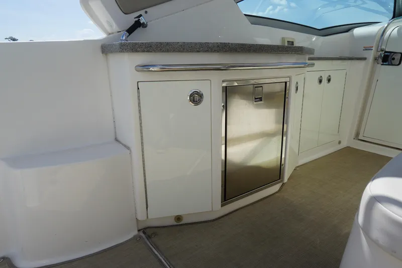 Slide: The Image of 2014 Chaparral 330 Signature yacht interior with kitchenette and stainless steel fridge. - 25