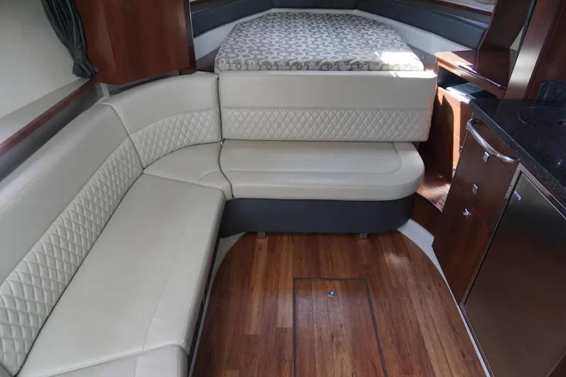 Slide: The Image of Interior of 2014 Chaparral 330 Signature boat with elegant seating and wood flooring. - 29