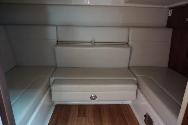 Slide: The Image of Interior cabin of 2014 Chaparral 330 Signature with beige seating and wooden flooring. - 34