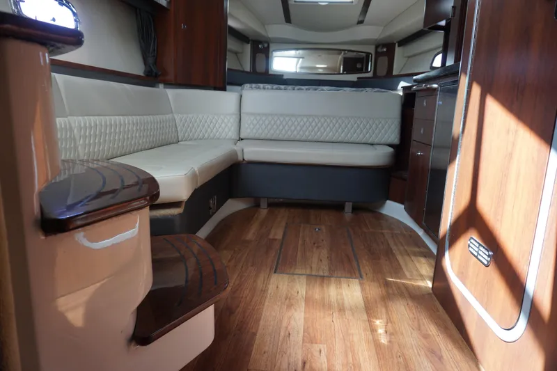 Slide: The Image of 2014 Chaparral 330 Signature interior with elegant seating and wood flooring. - 35