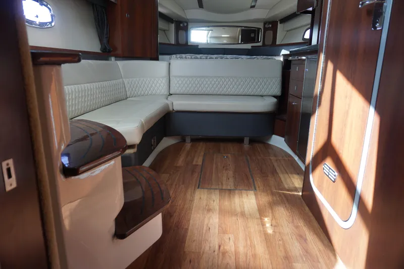 Slide: The Image of Interior of 2014 Chaparral 330 Signature boat with elegant seating and wood finish. - 36