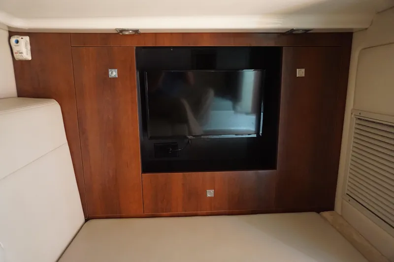 Slide: The Image of Interior of 2014 Chaparral 330 Signature yacht with mounted TV and wood paneling. - 37