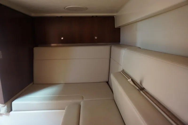 Slide: The Image of Interior cabin of 2014 Chaparral 330 Signature with beige seating and wooden accents. - 38
