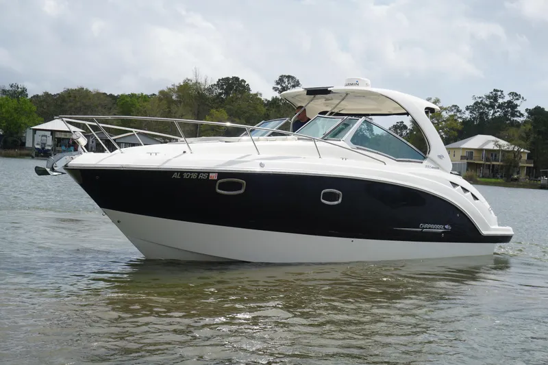 Slide: The Image of 2014 Chaparral 330 Signature boat on calm water, side view. - 6