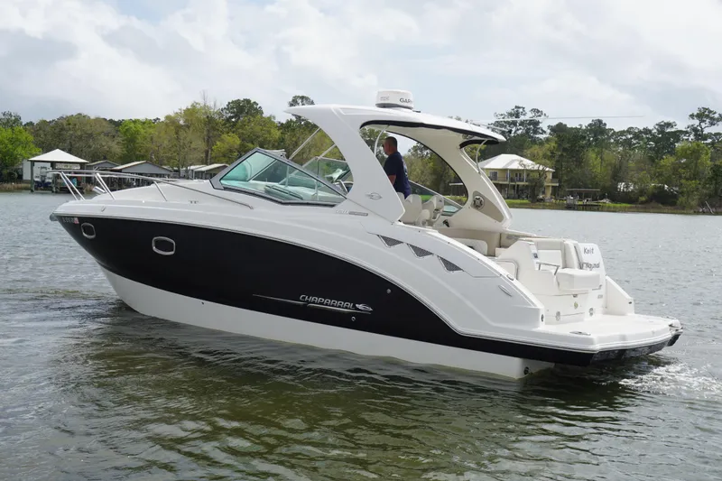 Slide: The Image of 2014 Chaparral 330 Signature boat cruising on a calm lake. - 7