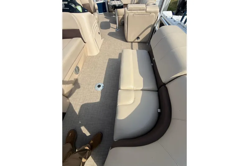 Slide: The Image of 2019 Sun Tracker SportFish 22 DLX interior with beige seating and carpeted floor. - 10