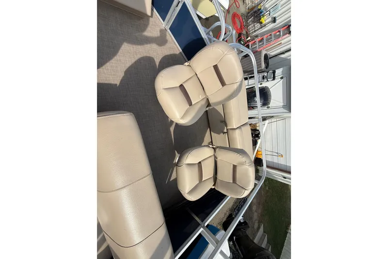Slide: The Image of 2019 Sun Tracker SportFish 22 DLX boat interior with beige seating and deck view. - 13