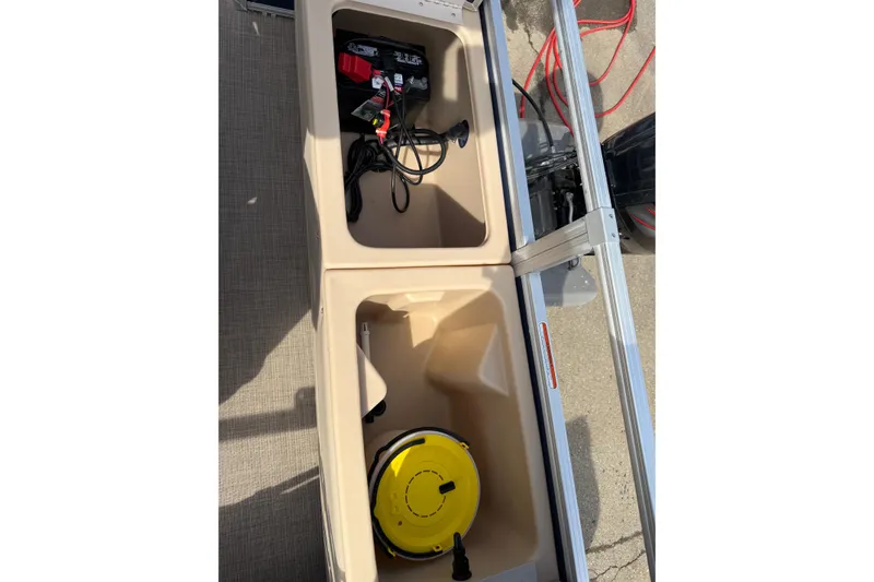Slide: The Image of 2019 Sun Tracker SportFish 22 DLX storage compartments with battery and equipment. - 14