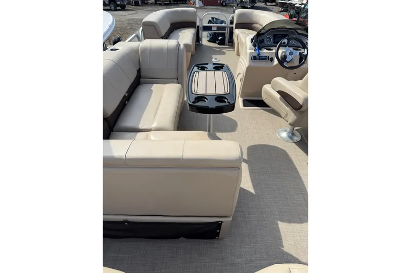 Slide: The Image of 2019 Sun Tracker SportFish 22 DLX interior with beige seating and steering console. - 15