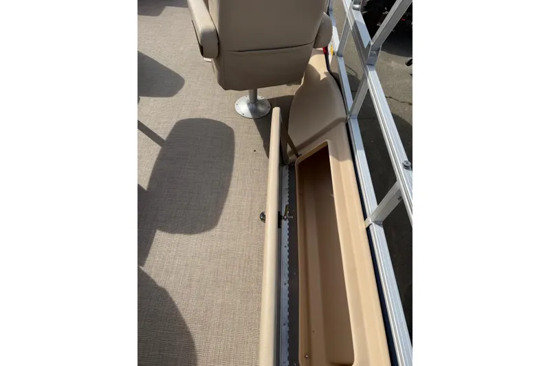 Slide: The Image of 2019 Sun Tracker SportFish 22 DLX interior with open storage compartment and seating. - 17