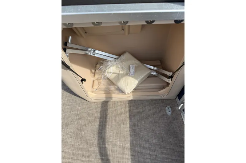 Slide: The Image of Storage compartment of 2019 Sun Tracker SportFish 22 DLX boat with packaged accessories. - 22