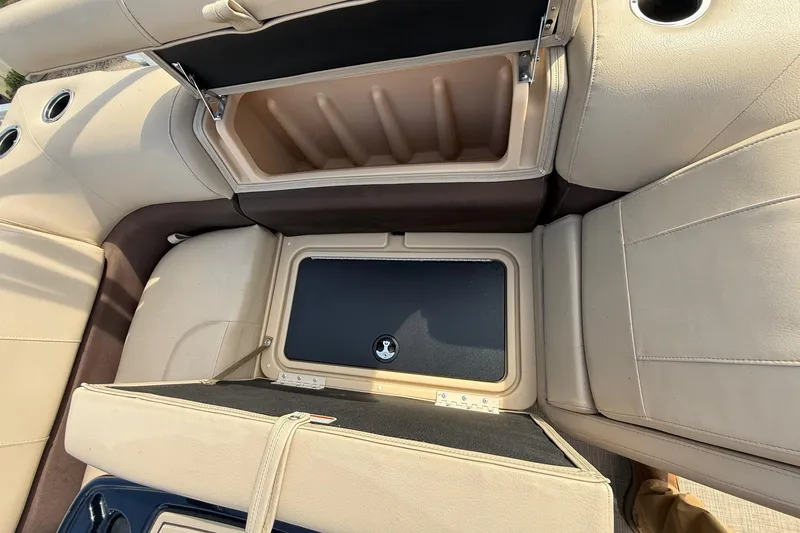 Slide: The Image of 2019 Sun Tracker SportFish 22 DLX boat interior storage compartments with beige upholstery. - 26