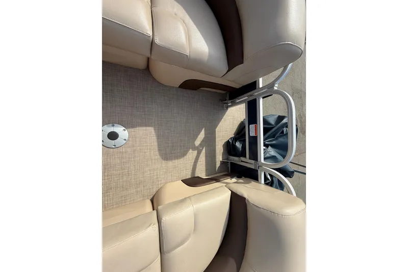 Slide: The Image of 2019 Sun Tracker SportFish 22 DLX boat interior with beige seating and metal railing. - 29