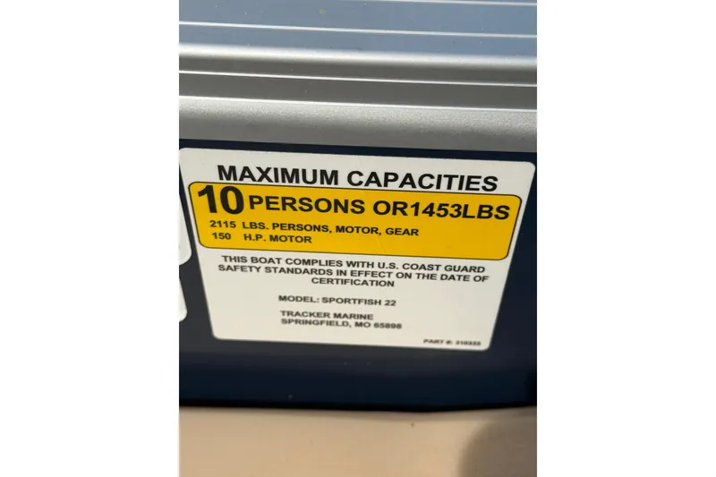 Slide: The Image of 2019 Sun Tracker SportFish 22 DLX capacity label: 10 persons or 1453 lbs, 150 HP motor. - 31