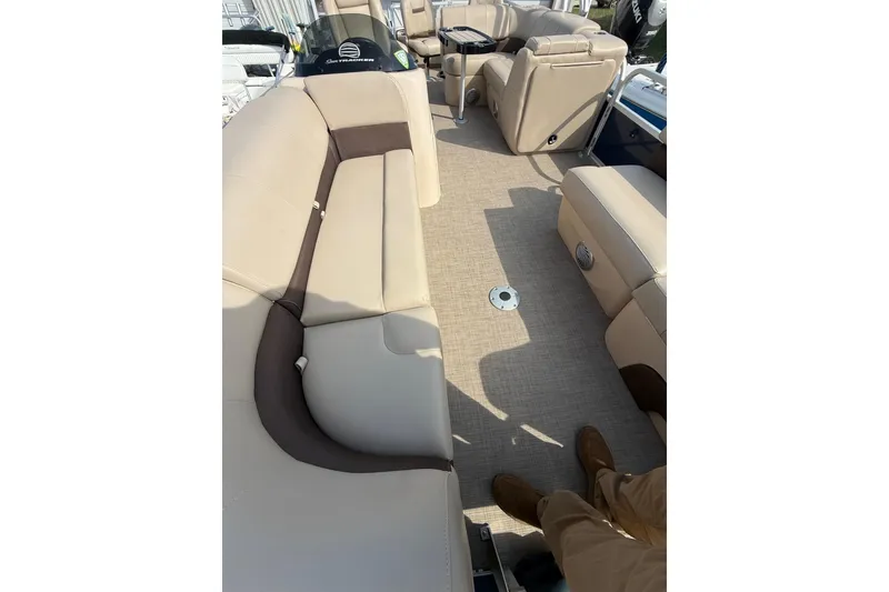 Slide: The Image of 2019 Sun Tracker SportFish 22 DLX interior with beige seating and spacious layout. - 9