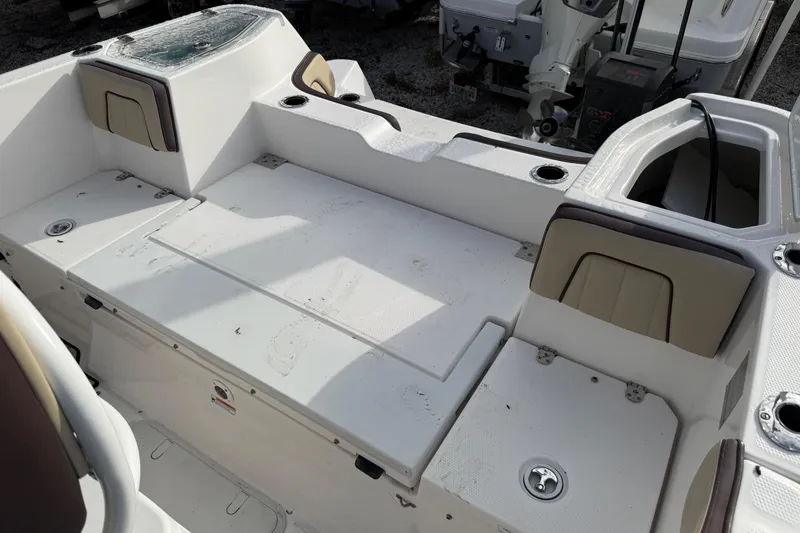 Slide: The Image of 2021 Yamaha Boats 255 FSH Sport E interior with seating and storage compartments. - 13