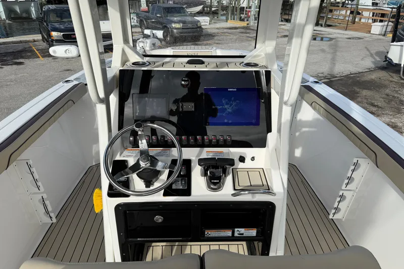 Slide: The Image of 2021 Yamaha Boats 255 FSH Sport E helm with steering wheel and navigation display. - 6