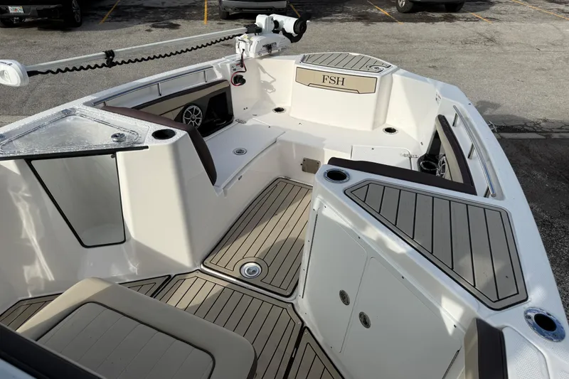 Slide: The Image of 2021 Yamaha Boats 255 FSH Sport E interior with seating and storage compartments. - 8