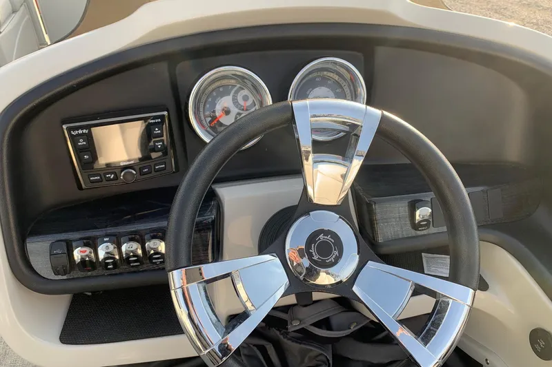 Slide: The Image of Steering console of 2018 Avalon 2585 Catalina Quad Lounger with gauges and controls. - 10