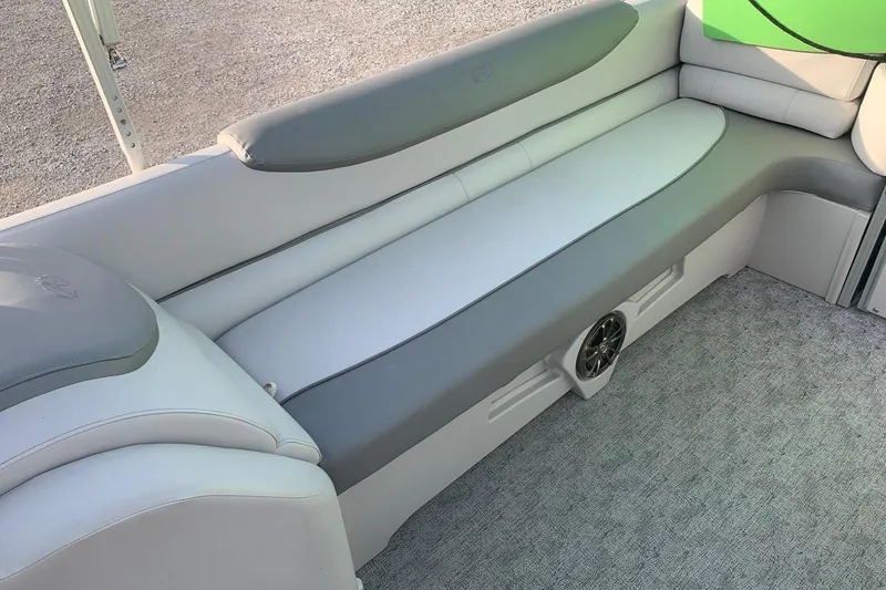 Slide: The Image of 2018 Avalon 2585 Catalina Quad Lounger interior with gray seating and speaker. - 12