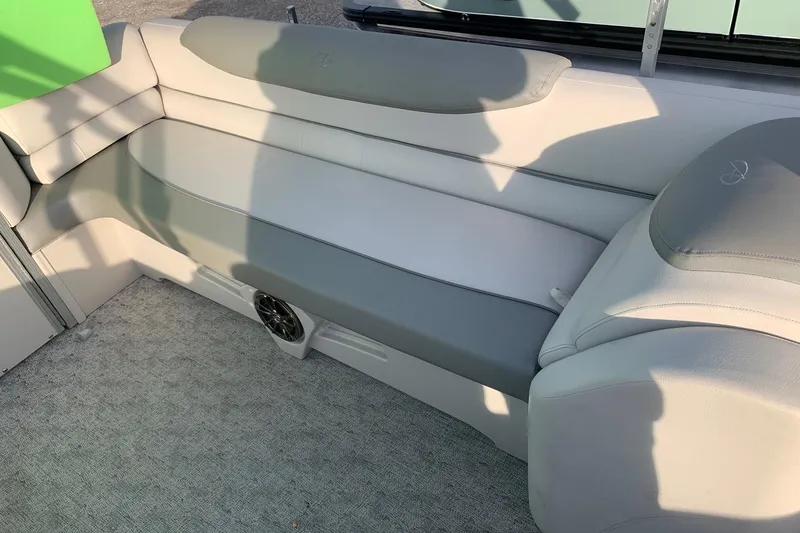 Slide: The Image of 2018 Avalon 2585 Catalina Quad Lounger interior with gray seating and speaker. - 13