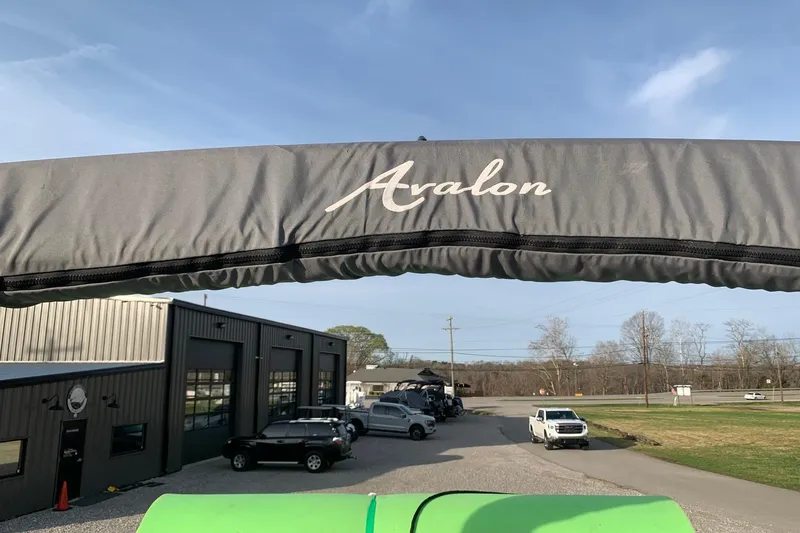 Slide: The Image of 2018 Avalon 2585 Catalina Quad Lounger canopy with dealership background. - 15