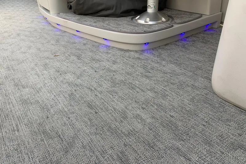 Slide: The Image of Carpeted interior of 2018 Avalon 2585 Catalina Quad Lounger with blue LED lights. - 18