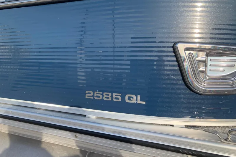 Slide: The Image of 2018 Avalon 2585 Catalina Quad Lounger boat, blue exterior with chrome detailing. - 20