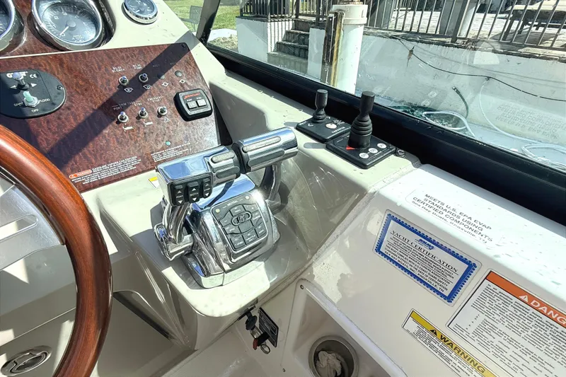 Slide: The Image of Cockpit of 2013 Sea Ray 370 Venture with steering wheel and control panel. - 11
