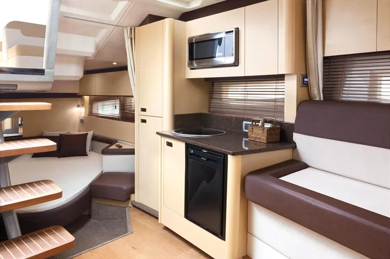 Slide: The Image of 2013 Sea Ray 370 Venture boat seats, beige and white upholstery, with cup holders. - 13