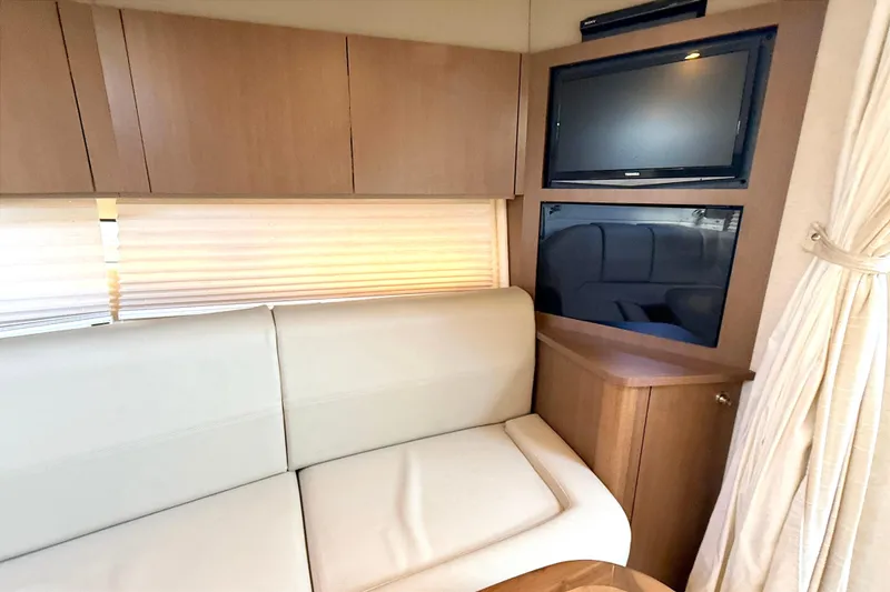 Slide: The Image of Cozy cabin interior of 2013 Sea Ray 370 Venture with plush bedding. - 17