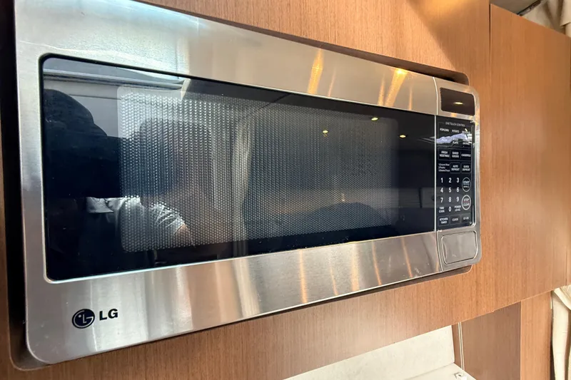 Slide: The Image of Luxurious interior of 2013 Sea Ray 370 Venture yacht with elegant wood table and plush seating. - 19