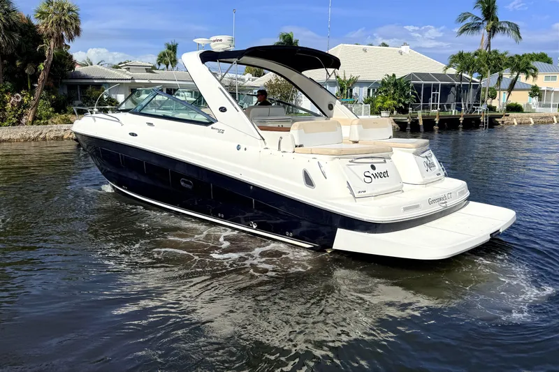 Slide: The Image of 2013 Sea Ray 370 Venture yacht in front of waterfront house. - 2