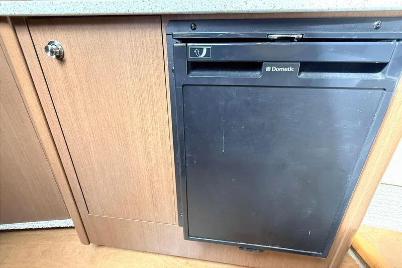 Slide: The Image of Interior of 2013 Sea Ray 370 Venture with TV, beige sofa, and wooden cabinetry. - 20