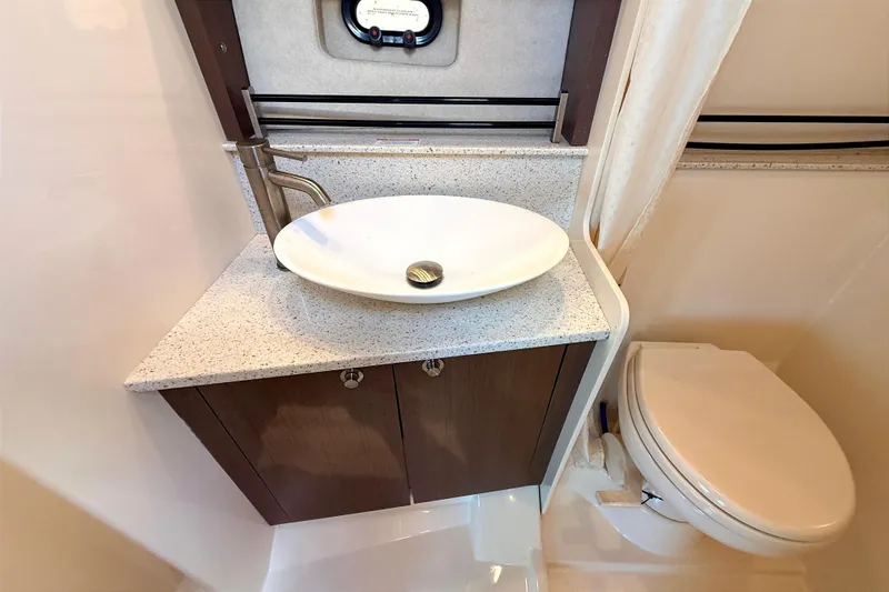 Slide: The Image of 2013 Sea Ray 370 Venture bathroom with modern sink and toilet. - 21