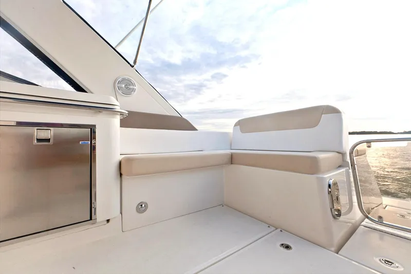 Slide: The Image of 2013 Sea Ray 370 Venture boat seating area with beige and white upholstery. - 4