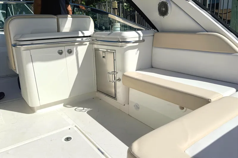 Slide: The Image of Manufacturer Provided Image: 2013 Sea Ray 370 Venture boat interior with seating and table, scenic water view. - 7
